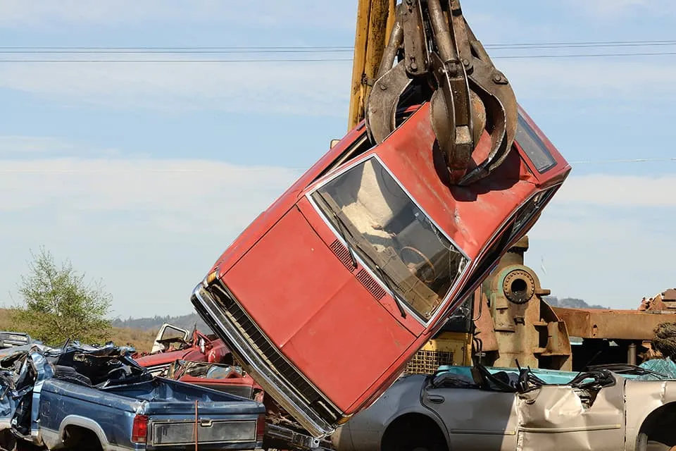 Older damaged vehicle in a lot — The Buy Center of Enfield buys cars in any condition